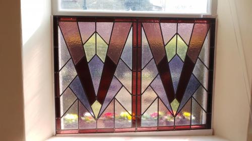 Art Deco panel placed in front of a window to act as privacy screen